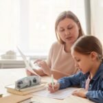 Parent teaching preschool child at home using Christianbook homeschool curriculum with coupon code savings for kindergarten learning materials