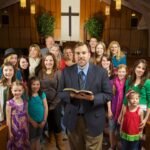 Christian family reading the Bible together at home while exploring Christianbook coupon code deals for faith-based books, devotionals, and educational resources.