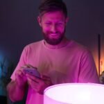 Modern homeowners using Lumary Smart LED recessed lighting in a stylish living room while saving money with verified Lumary coupon code deals